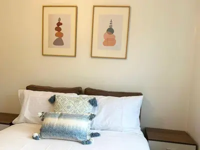 a bedroom with two pictures on the wall and a bed at KH-Entire House -Central Scotland, Self-Check-in , Pet-friendly and with Parking in Falkirk