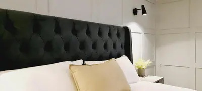 a bed with a black padded headboard in a room at 5 Oban in Oban