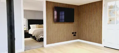 a bedroom with a bed and a wall with stripes at 5 Oban in Oban