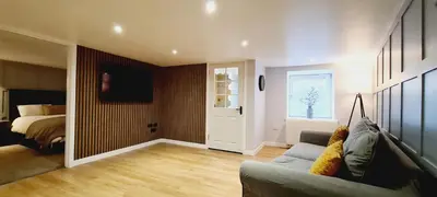 a living room with a couch and a bedroom at 5 Oban in Oban