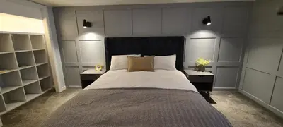 a bedroom with a large bed with two night stands at 5 Oban in Oban