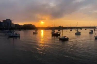 a group of boats in the water at sunset at Peace in the City in Edinburgh