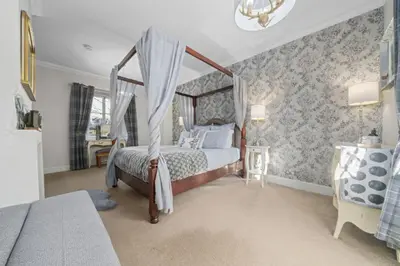 a bedroom with a canopy bed in a room at The Strone Luss Premium Holiday Rental in Luss