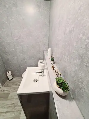 a bathroom with a white sink and a counter at Cozy Flat in Glasgow City Centre in Glasgow