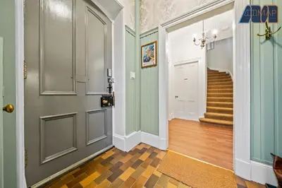 a hallway with a door and stairs in a house at Historic 3 Bed Private Parking Nr Railway Station in Wemyss Bay
