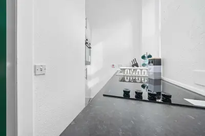 a room with a mirror and a shelf with boots at Central Kirkintilloch 2 Bed App in Kirkintilloch