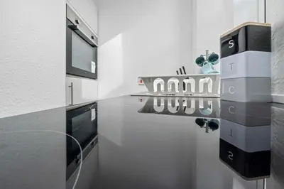 a kitchen with a counter with glasses on it at Central Kirkintilloch 2 Bed App in Kirkintilloch