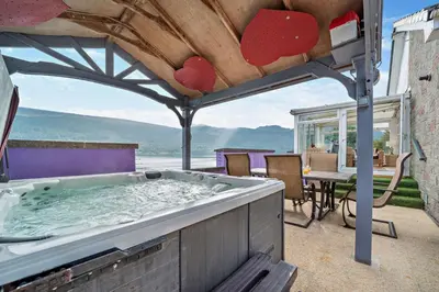 a hot tub on a patio with a table at 4 Bed in Lochgoilhead oc-j30107 in Carrick