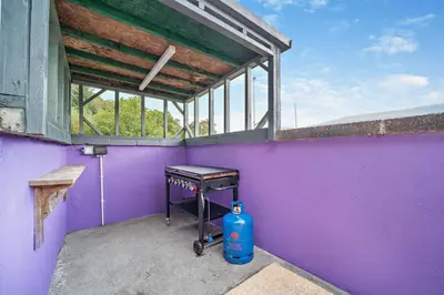 a room with a purple wall with a table and a window at 4 Bed in Lochgoilhead oc-j30107 in Carrick