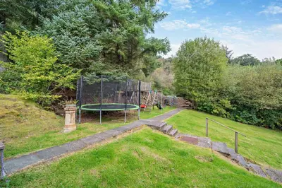 a park with a playground with a trampoline at 4 Bed in Lochgoilhead oc-j30107 in Carrick