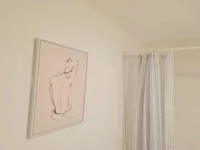 a drawing of a woman on a wall in a bathroom at Cosy flat in Glasgow in Maryhill