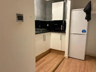 a kitchen with a white refrigerator and a wooden floor at VS-Entire Flat-Central Scotland-Falkirk, Self-Check-in , Pet-friendly with Parking in Falkirk