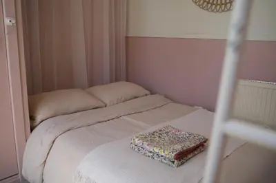 a small bedroom with a bed with a pillow on it at 20min train to Edinburgh, The Coorie Inn in Inverkeithing
