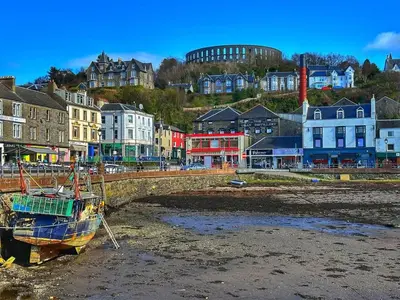a boat sitting on the shore of a beach at 17 Oban in Oban
