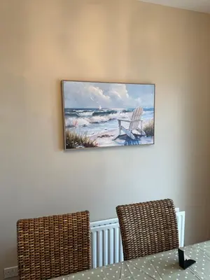 a painting of a chair on a wall at Church Bay House Rathlin in Rathlin Island