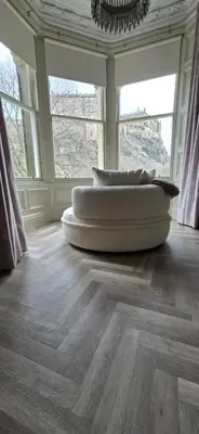 a room with two pillows on a wooden floor with windows at 2 Bedroom Sofa bed in livingroom Castle View 1st floor sleeps 6 in Edinburgh