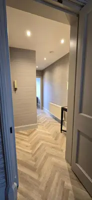 a hallway with wooden floors and a door at 2 Bedroom Sofa bed in livingroom Castle View 1st floor sleeps 6 in Edinburgh