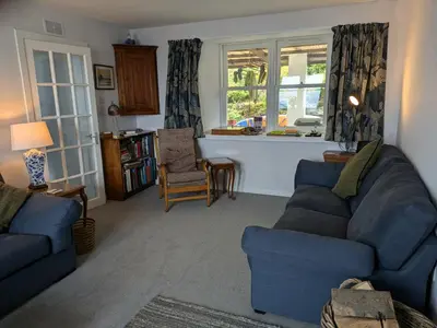 a living room with a blue couch and chairs at Tigh Grianach in Port Charlotte