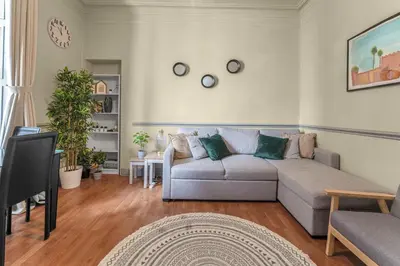 a living room with a couch and a tv at Central, Cozy 2BR-1BA-Haymarket - with Parking in Edinburgh