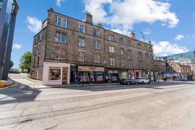 a large brick building on the corner of a street at Central, Cozy 2BR-1BA-Haymarket - with Parking in Edinburgh