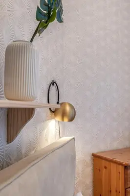 a white vase on a shelf with a flower in it at Central, Cozy 2BR-1BA-Haymarket - with Parking in Edinburgh