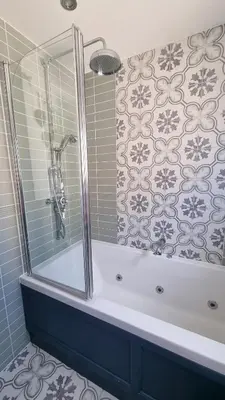 a bathroom with a bath tub with a shower at Innisfail Edi - double room with private bathroom in Edinburgh