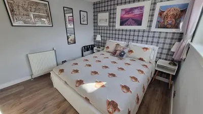a bedroom with a bed with cats on it at Innisfail Edi - double room with private bathroom in Edinburgh