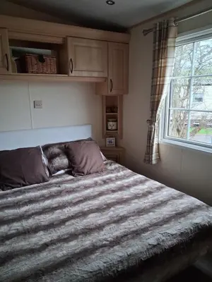 a bedroom with a large bed with a window at St Nicholas Number 5 in Turnberry
