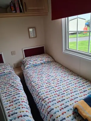 a bedroom with two beds and a window at St Nicholas Number 5 in Turnberry