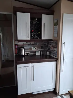 a kitchen with white cabinets and a counter top at St Nicholas Number 5 in Turnberry