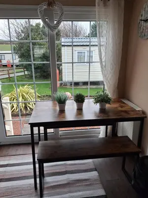 a table in front of a window with potted plants on it at St Nicholas Number 5 in Turnberry