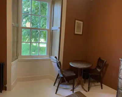 a room with a table and two chairs and a window at Gorgeous boutique off-grid cottage near Peebles in Peebles