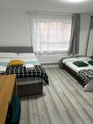 a bedroom with two beds and a window at private Studio with its own kitchen and bathroom in Moffat