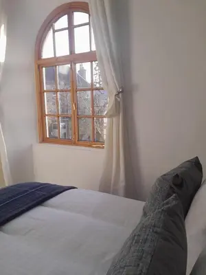 a bedroom with a bed and a window at Doune 3 Outlander Apartment 1st floor in Stirling