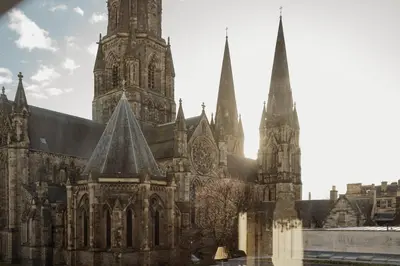 an old cathedral with two towers in a city at Prestigious Townhouse close to Princes Street in Edinburgh