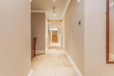 a hallway of a home with white walls and tile floors at Large Central 3 Bed 3 Bath Apartment - New Town in Edinburgh