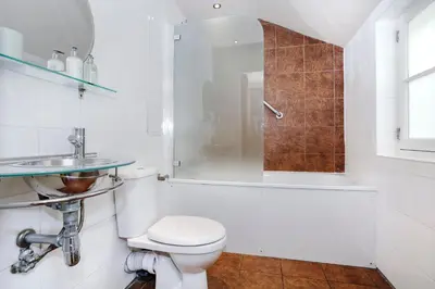 a bathroom with a toilet and a sink and a shower at Large Central 3 Bed 3 Bath Apartment - New Town in Edinburgh