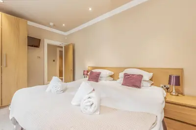 a bedroom with two beds with towels on them at Large Central 3 Bed 3 Bath Apartment - New Town in Edinburgh