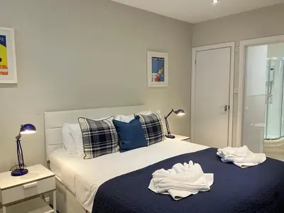 a bedroom with a bed with towels on it at Park Mews Glasgow in Glasgow
