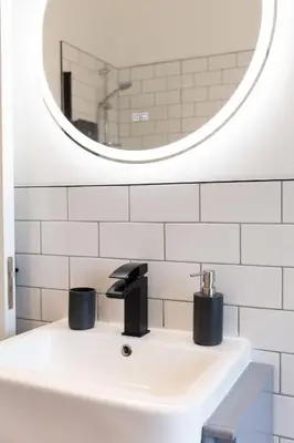 a bathroom with a sink and a mirror at The Annick Suite No1 - Donnini Apartments in Irvine