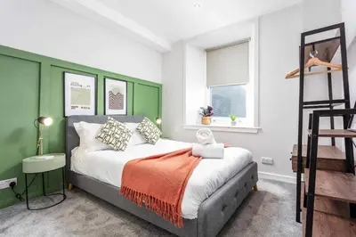 a bedroom with a bed and a ladder at The Annick Suite No2 - Donnini Apartments in Irvine