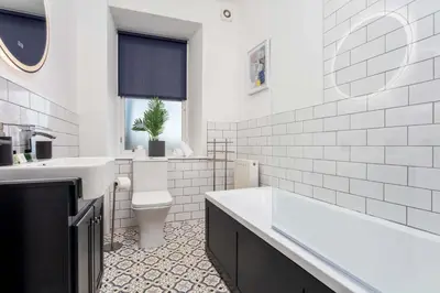 a bathroom with a tub and a toilet and a sink at The Annick Suite No2 - Donnini Apartments in Irvine