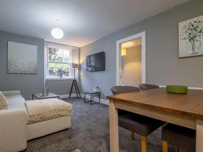 a living room with a couch and a table at Happy Haven Home, West End - Pass the Keys in Glasgow