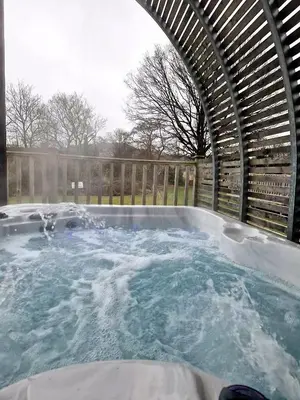 a jacuzzi hot tub with snow on the ground at The Ness, Lodge with Hot Tub in Crieff