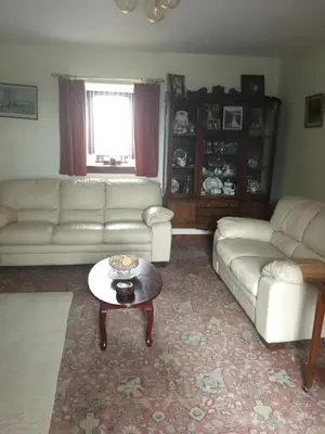 a living room with a couch and a coffee table at Farmhouse in Clydebank
