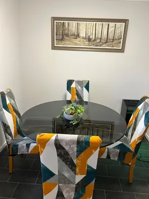 a dining room table with chairs and a bowl of plants at Spacious 2 bedroom apartment, entire place in Greenock