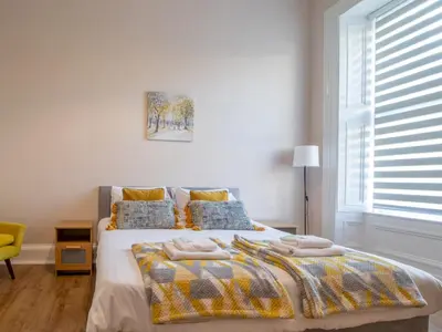 a bedroom with a bed with two towels on it at City Haven Main Door & Parking - Pass the Keys in Glasgow