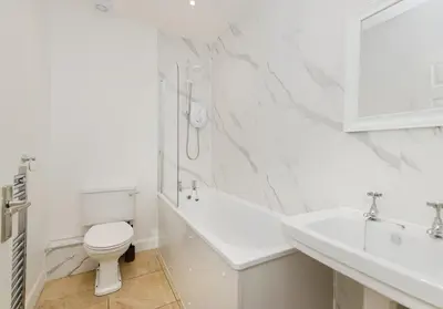 a white bathroom with a toilet and a sink at Argyl - Grassmarket Apartments in Edinburgh