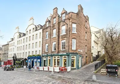 a large brick building on the side of a street at Argyl - Grassmarket Apartments in Edinburgh