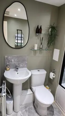 a bathroom with a toilet and a sink and a mirror at Modern Room in a Shared Flat near Haymarket in Edinburgh